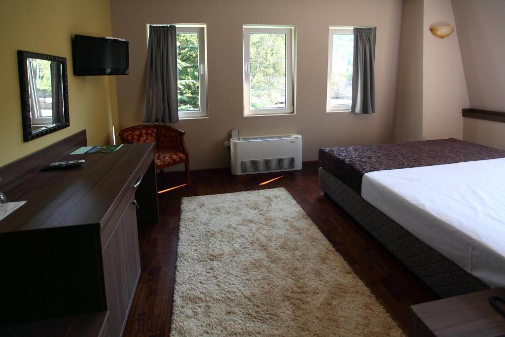 Postel nebo postele na pokoji v ubytování Hotel Šator