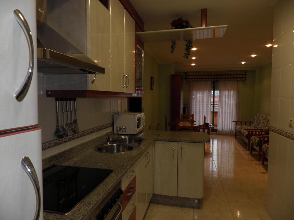 a kitchen with a sink and a counter top at Milano in Sanxenxo