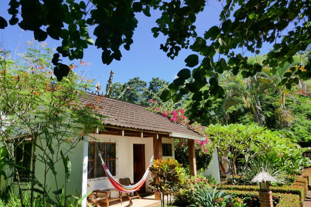 a small house with a hammock in front of it at Escape Caribeño in Puerto Viejo