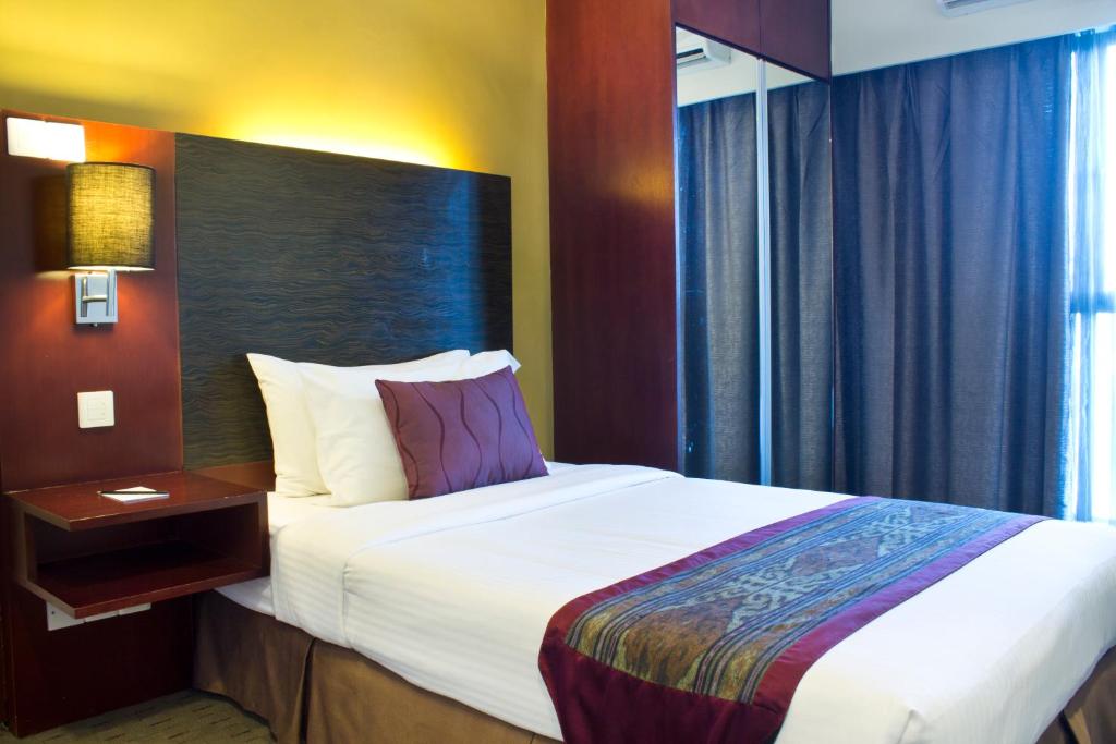 Postel nebo postele na pokoji v ubytování Ming Garden Hotel & Residences