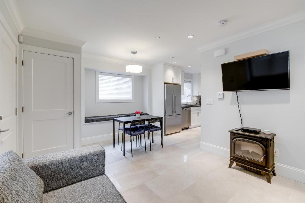 a living room with a couch and a table at New Urban Modern Main Street House in Vancouver