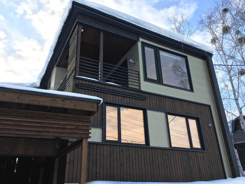 a house with windows on the side of it at Fuyunoki in Furano