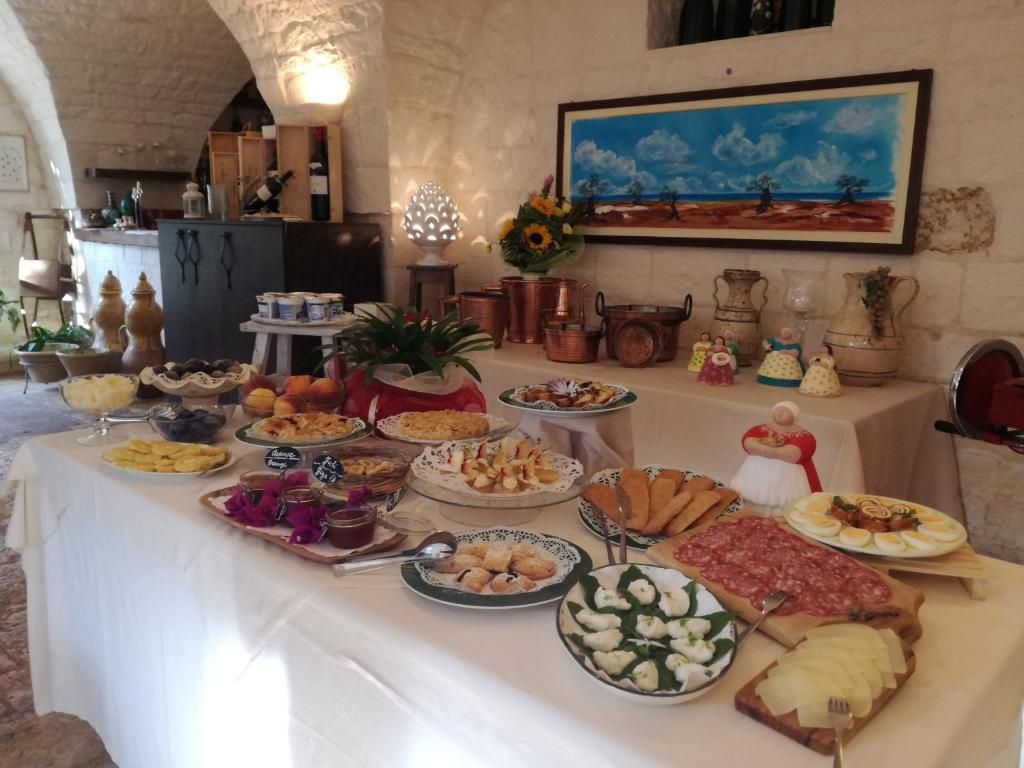 a table with many different types of food on it at Masseria Asciano in Ostuni