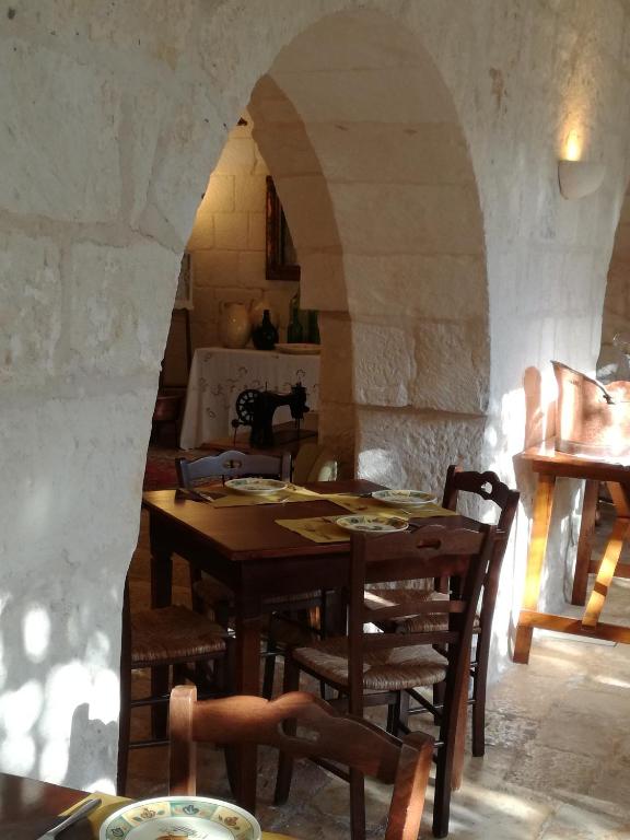 a dining room with a table and some chairs at Masseria Asciano in Ostuni