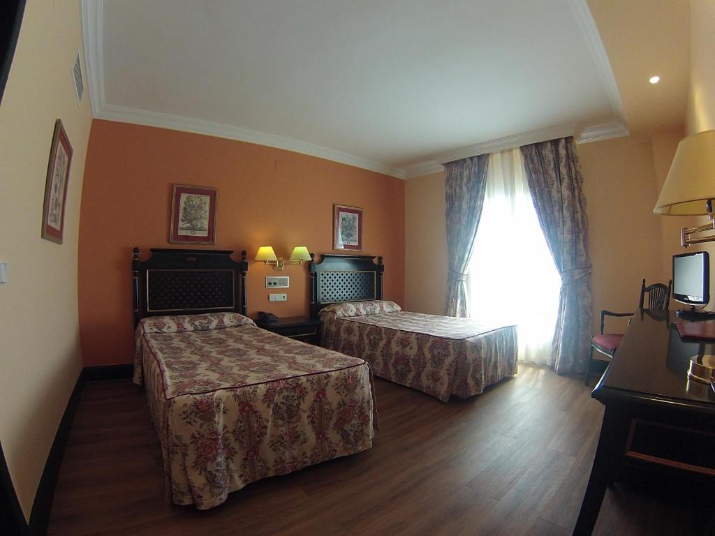 Postel nebo postele na pokoji v ubytování Hotel Cristina
