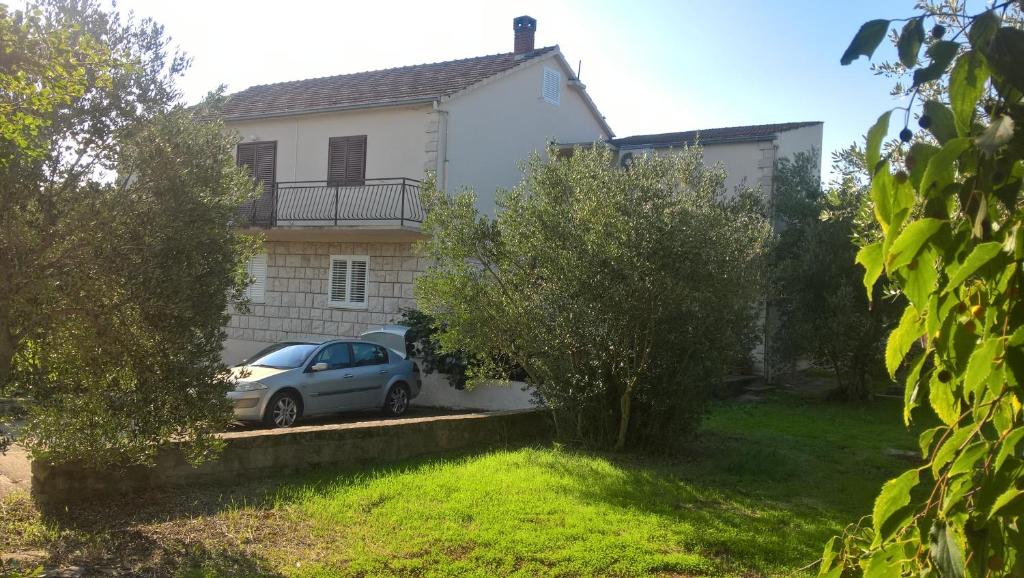 a car parked in front of a white house at 2 Apartm for rent in Korcula in Korčula