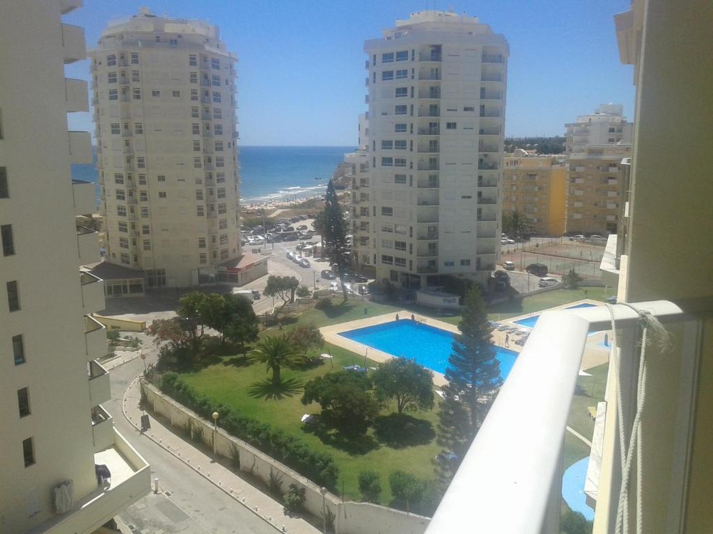 a view of a pool from a balcony of a building at Carol Beach House in Armação de Pêra