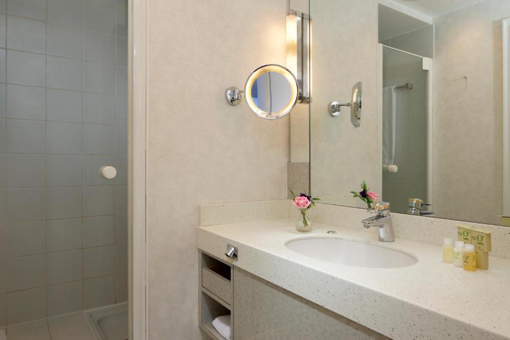 a bathroom with a sink and a mirror at Hotel Parc Belair in Luxembourg