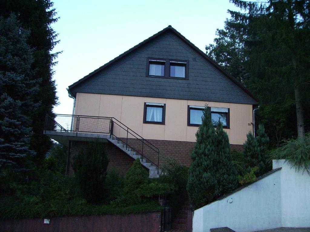 a house with a staircase on the side of it at Ferienwohnung Andrea in Eberbach
