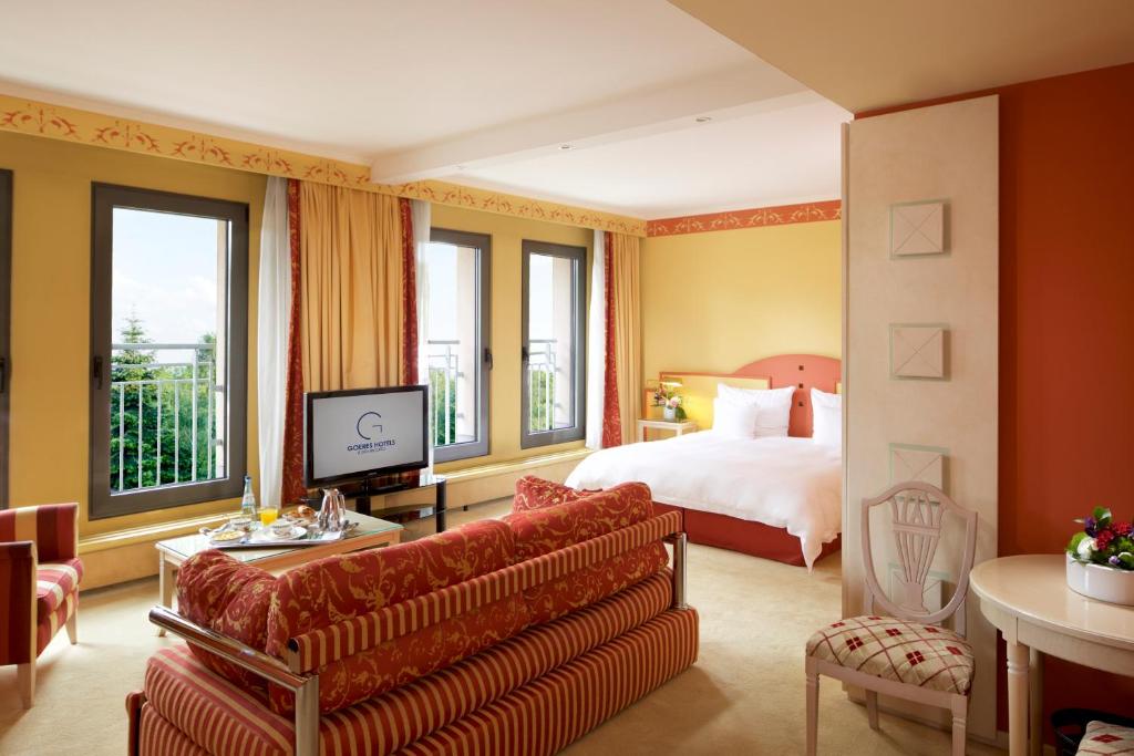 a hotel room with a bed and a television at Hotel Parc Belair in Luxembourg