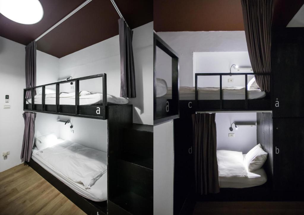 a room with three bunk beds in it at We Come Hostel in Taipei