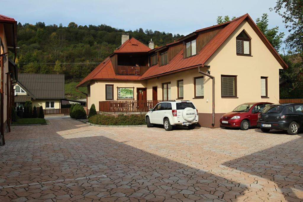 a white car parked in front of a house at Chalupa LUKA Terchová in Terchová