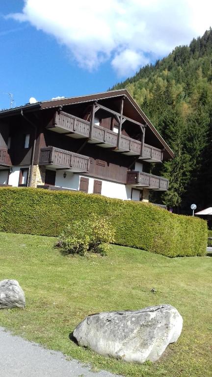 a house on a hill with a rock in front of it at cimes d'or in Les Contamines-Montjoie