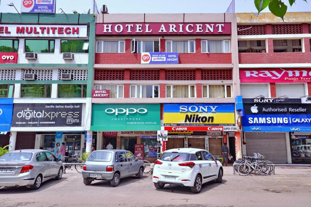 a group of cars parked in front of a building at Hotel Aricent in Chandīgarh