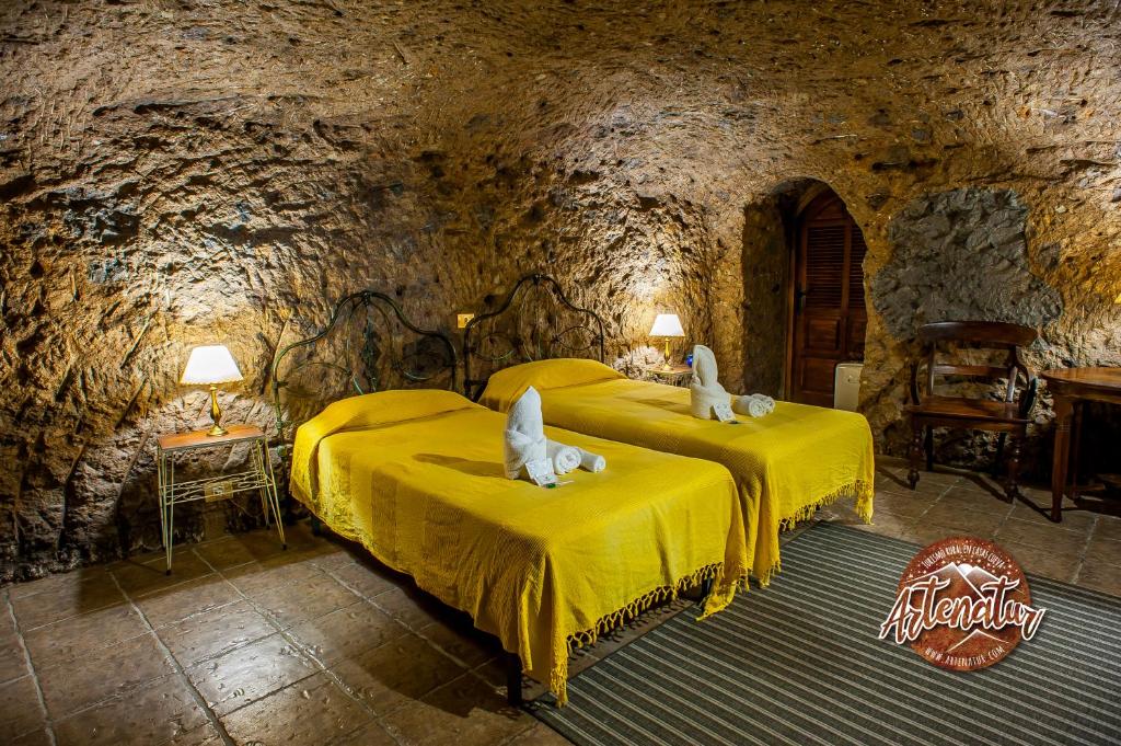 Posteľ alebo postele v izbe v ubytovaní Casa Cueva El Mimo