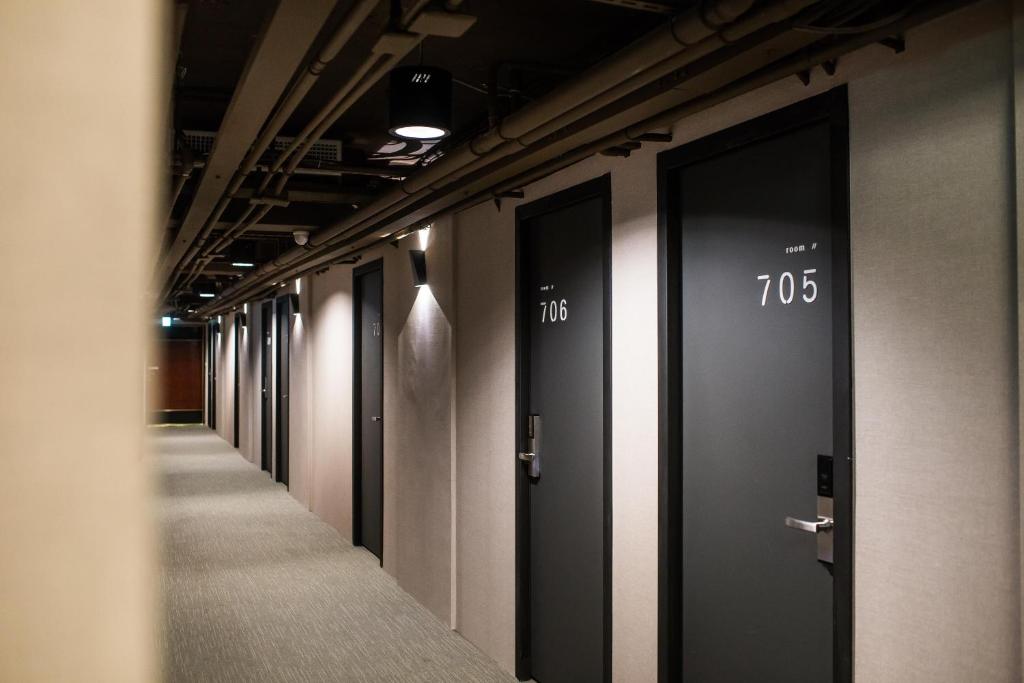 a row of elevators in a hallway of a building at We Come Hostel in Taipei