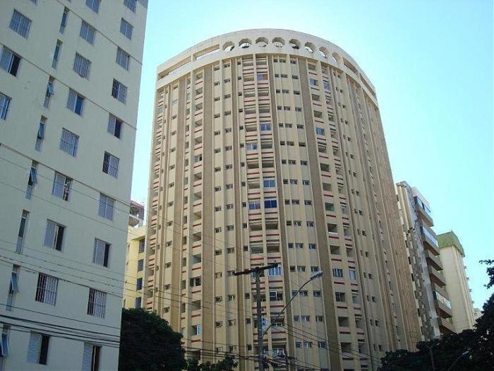 a large building next to two tall buildings at Flat Oeste La Residence in Goiânia