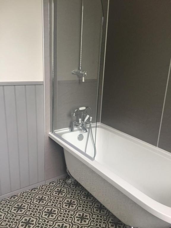uma casa de banho com uma banheira e um lavatório em Braeside em Alnwick