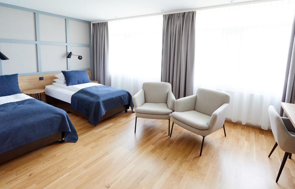 Postel nebo postele na pokoji v ubytování Fosshotel Reykholt