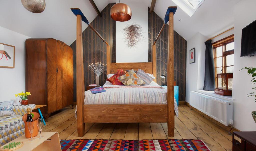 a bedroom with a bed with a wooden headboard at Mount Pleasant Farm in Wedmore