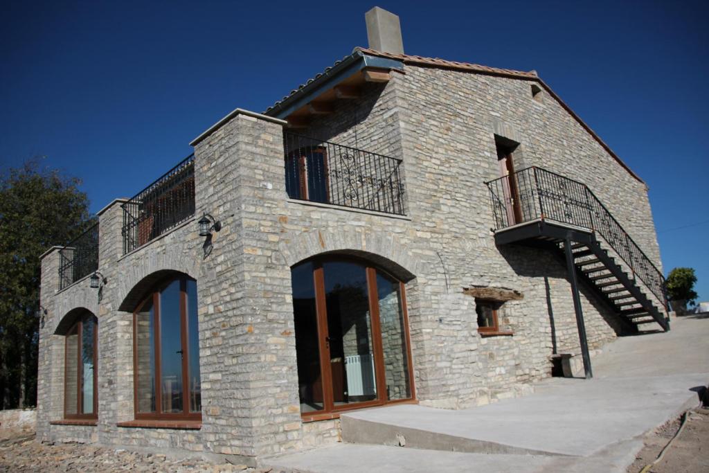 a building with a staircase on the side of it at Casa Mestres in Pujalt