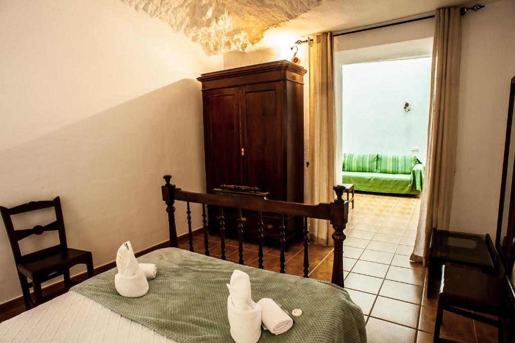 Postel nebo postele na pokoji v ubytování Casa Cueva El Molino