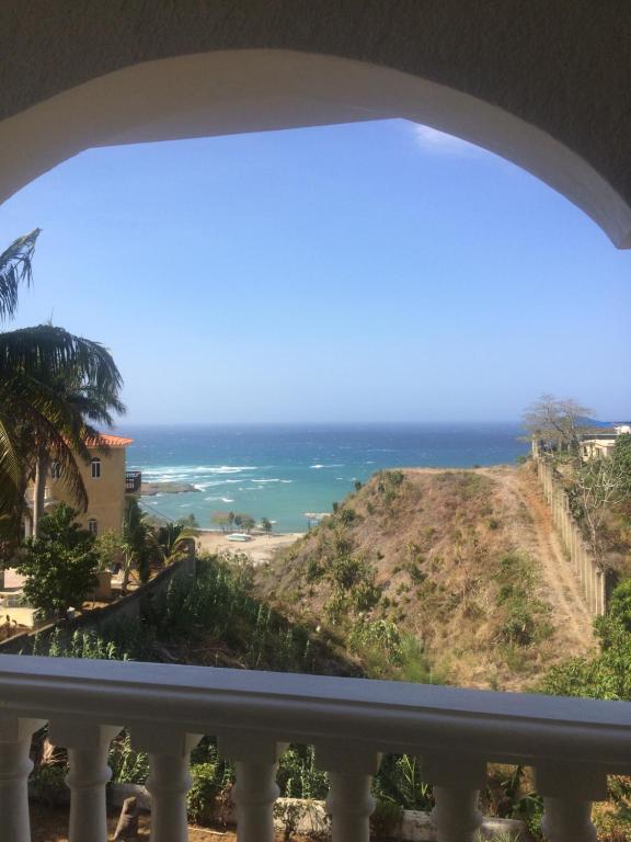 a view of the ocean from a balcony at Peaceful Ocean View Studio in San Felipe de Puerto Plata