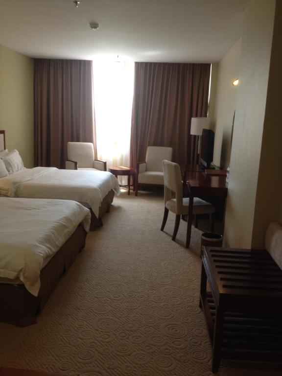 Postel nebo postele na pokoji v ubytování Gaya Centre Hotel