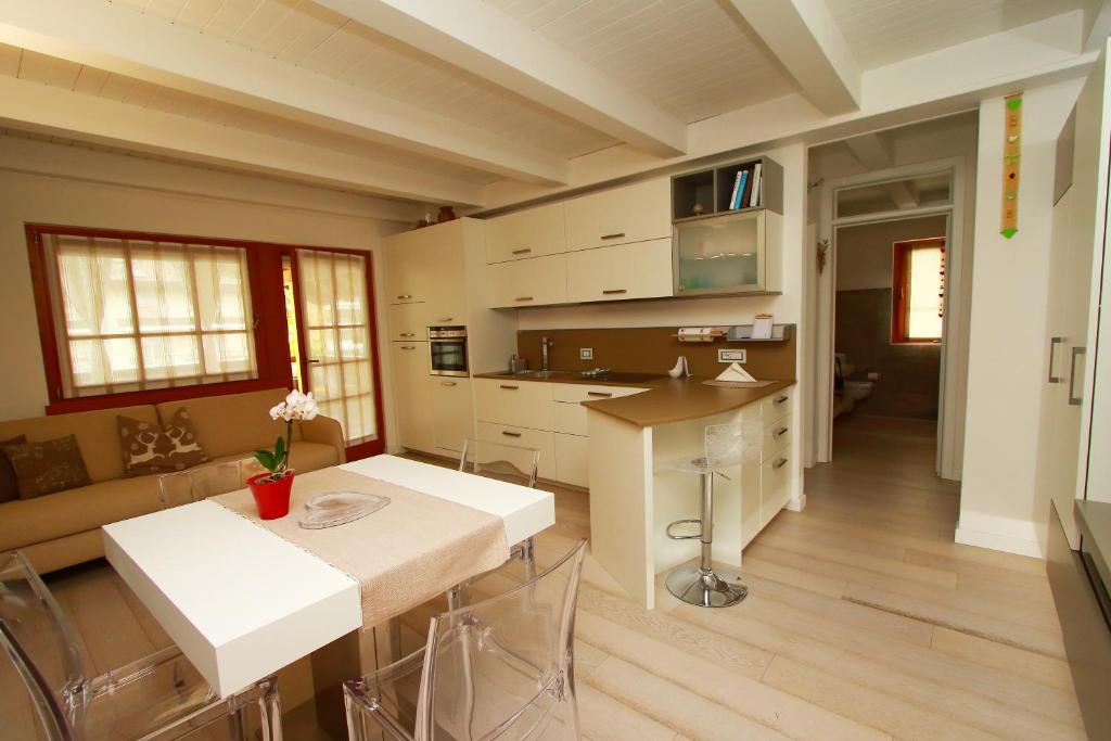 una cucina e un soggiorno con tavolo e sedie di Home White a Laives
