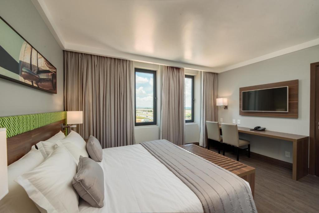 Cama ou camas em um quarto em Linx Confins