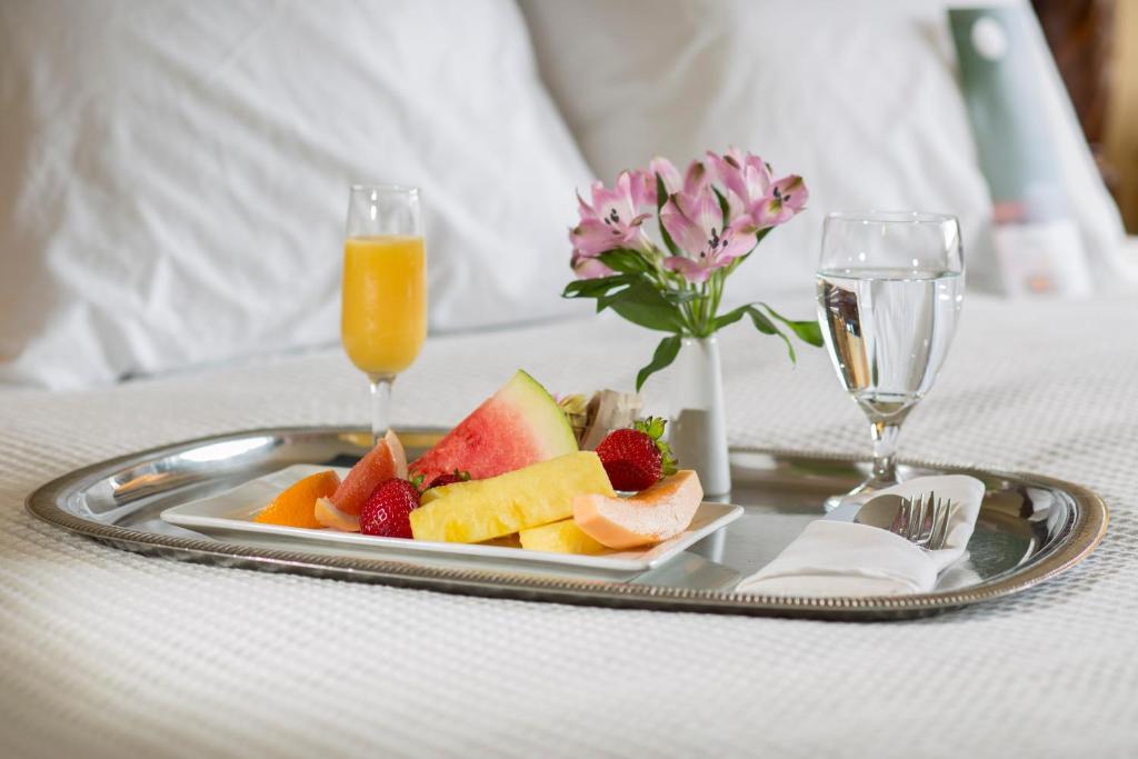 a tray with a plate of fruit on a table at Carnegie Hotel & Spa in Johnson City