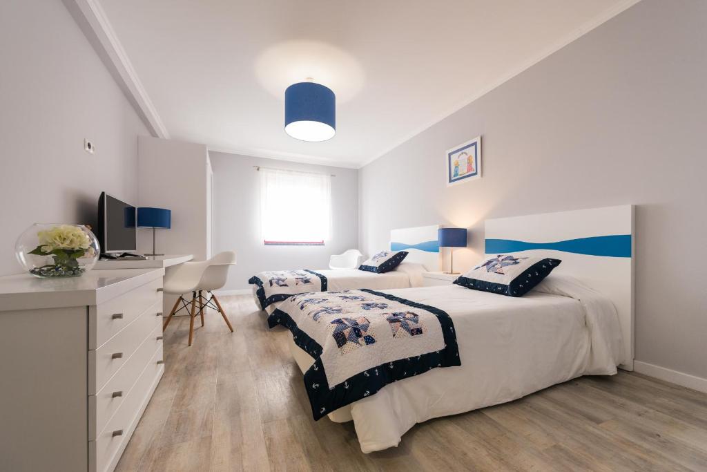 Postel nebo postele na pokoji v ubytování Ilhéu do Areeiro