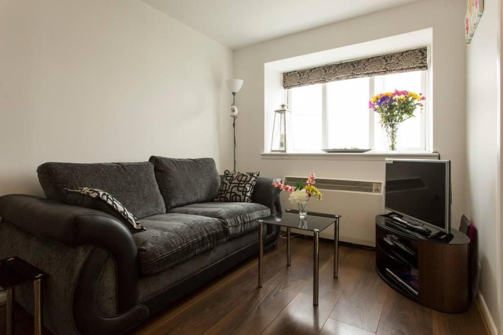 a living room with a couch and a television at Riverside View in Grays Thurrock