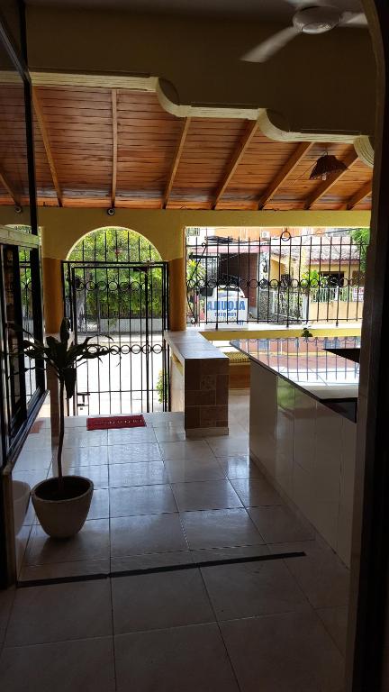 a view of a room with a table and windows at Caribbean Hotel Santo Domingo in Santo Domingo