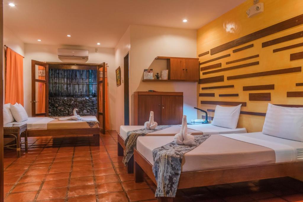 Postel nebo postele na pokoji v ubytování Acacia Tree Garden Hotel