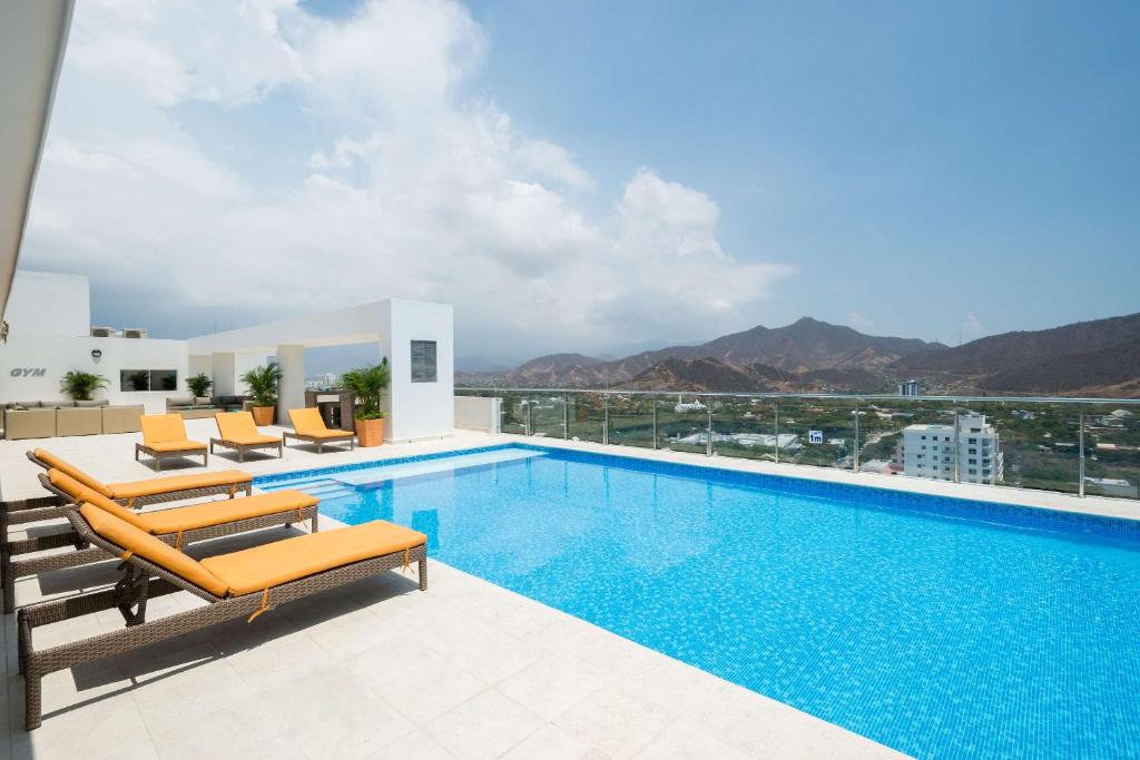 a swimming pool with a view of the mountains at Best Western Plus Santa Marta Hotel in Santa Marta