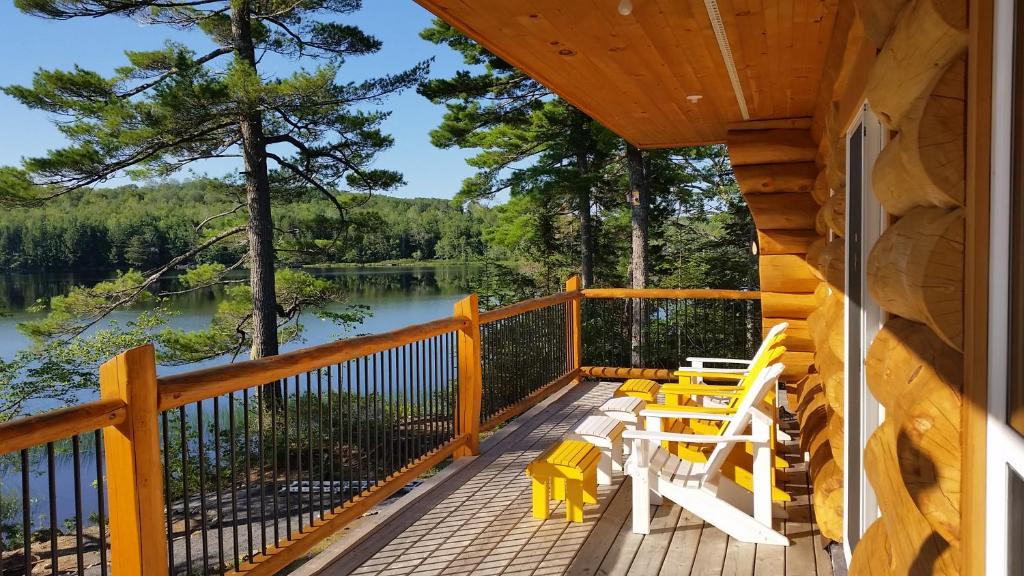 a deck with chairs and a view of a lake at Sunrise Pines in Colpton