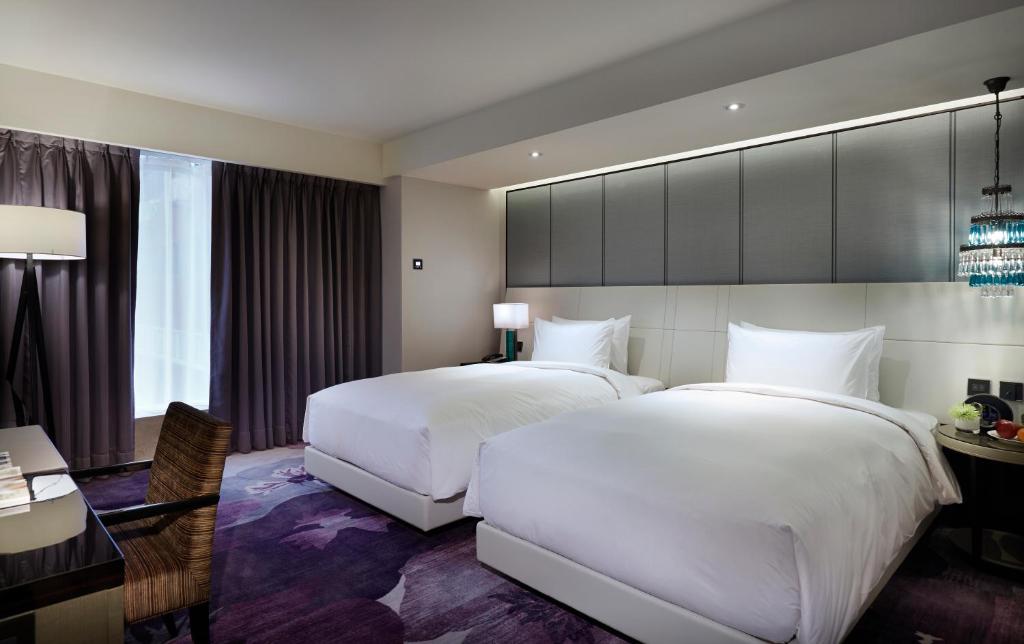 Postel nebo postele na pokoji v ubytování Taipei Fullerton Hotel-Maison North
