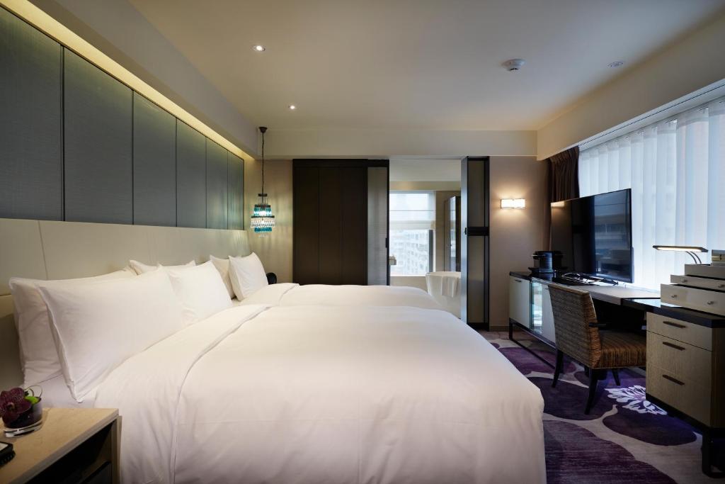 Postel nebo postele na pokoji v ubytování Taipei Fullerton Hotel-Maison North