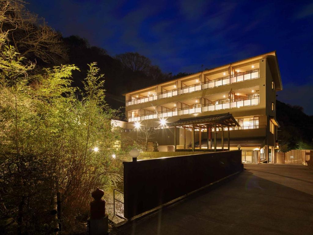 a large building at night with lights at Okuno Hosomichi in Kobe