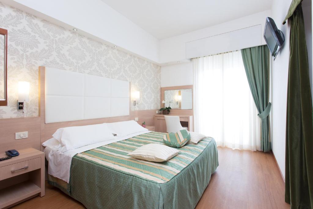Postel nebo postele na pokoji v ubytování Michelangelo Cesenatico