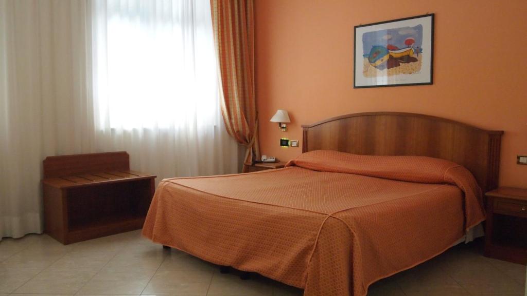 Postel nebo postele na pokoji v ubytování Piccolo Hotel