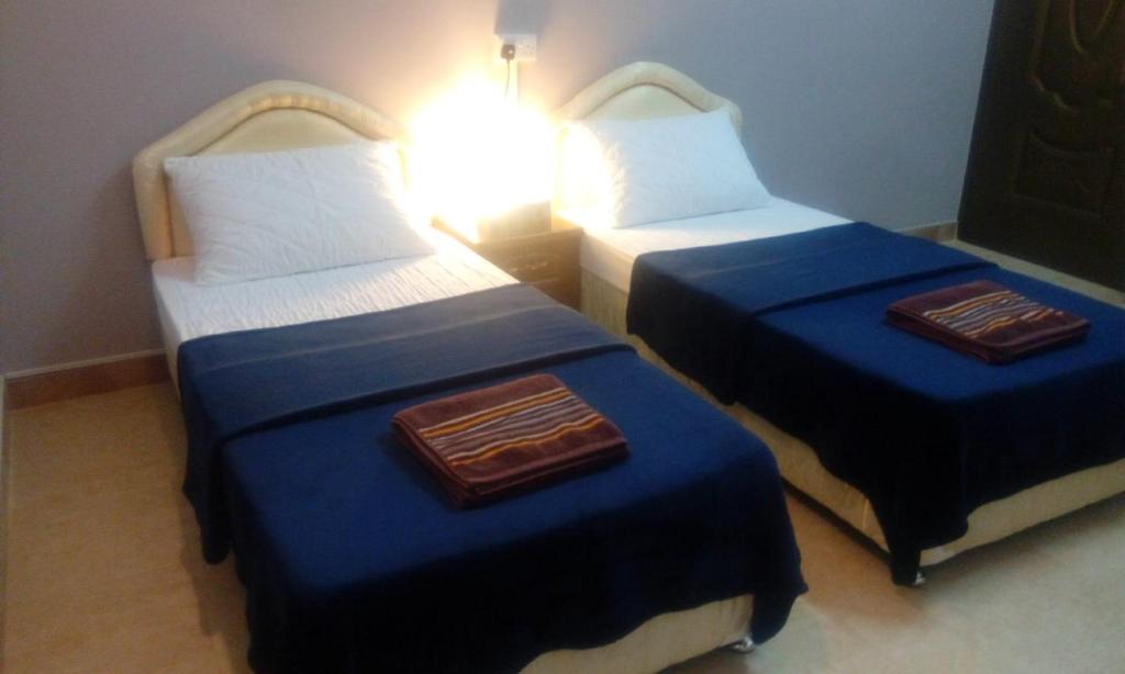 Postel nebo postele na pokoji v ubytování Al Hamra Guest House