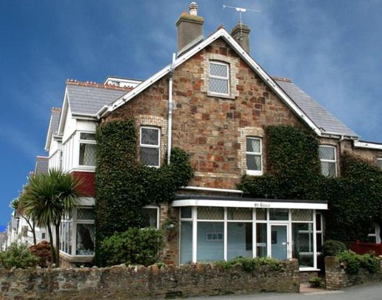 a brick house with ivy on the side of it at St Breca in Newquay