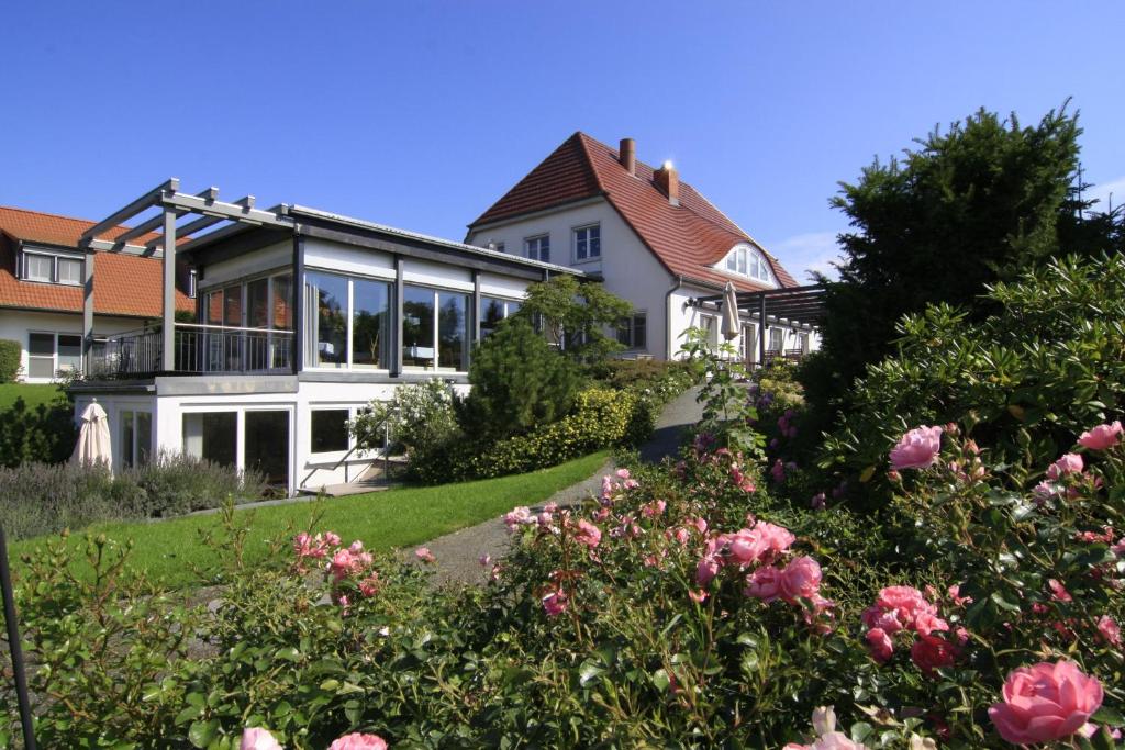 ein Haus mit Garten davor in der Unterkunft H.W.S. Hotel Der Wilde Schwan in Sagard