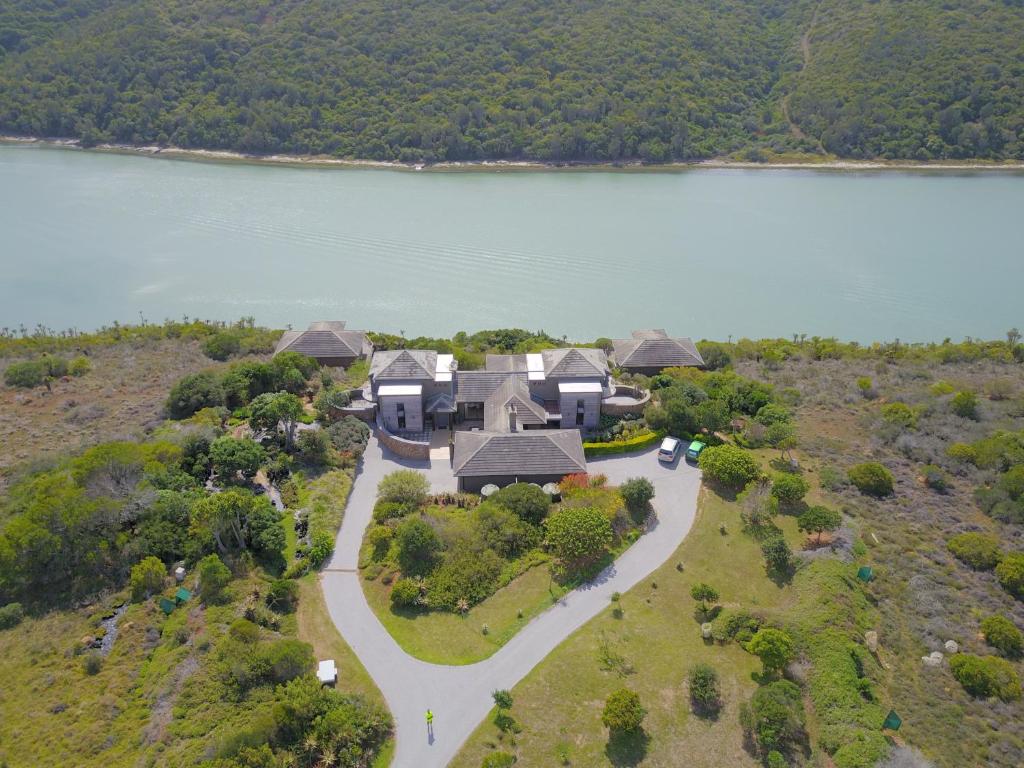 an aerial view of a house on a hill next to a lake at Nature's Cottage in Kenton on Sea