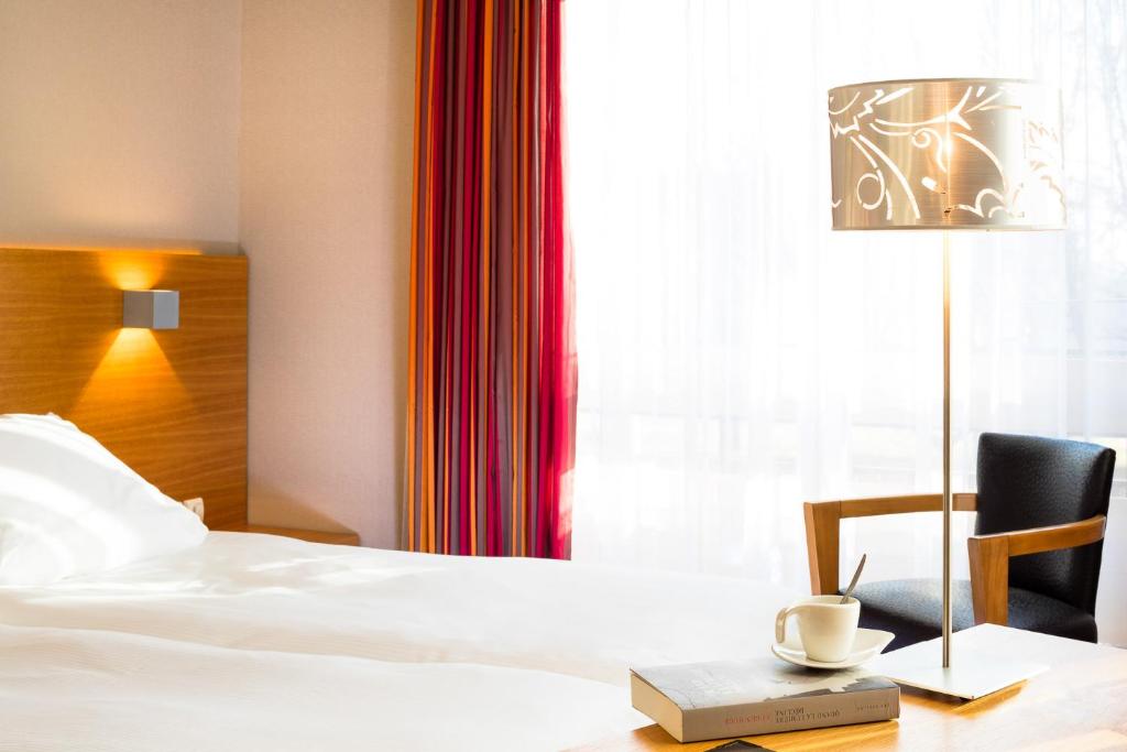 Postel nebo postele na pokoji v ubytování Hôtel Restaurant Logis Auberge Sundgovienne
