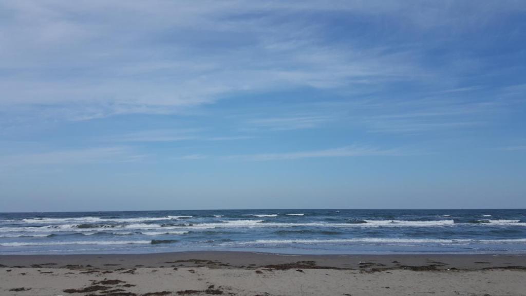 a person standing on a beach near the ocean at B&B Verrazzano affittacamere in Sottomarina