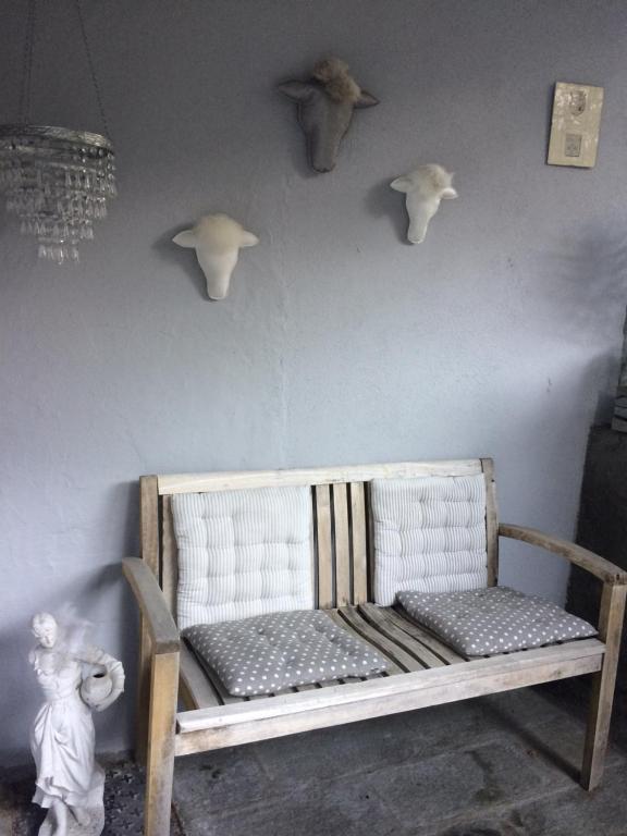 a room with a bench and skulls on the wall at Bed end breakfast du centre in Bourg-Saint-Maurice