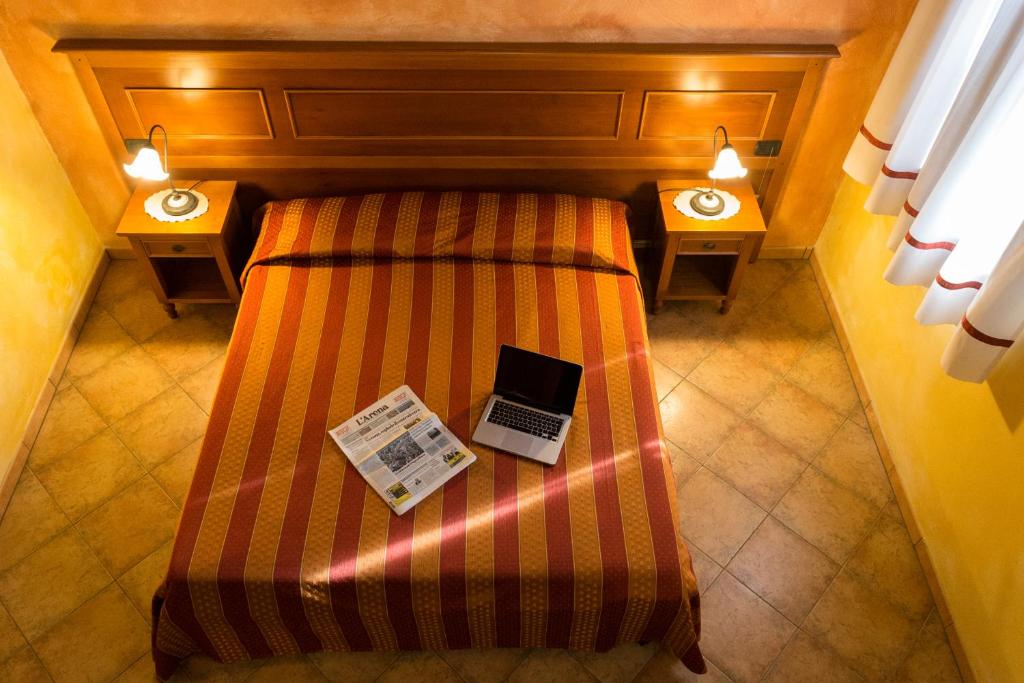 Postel nebo postele na pokoji v ubytování Agriturismo Tre Rondini